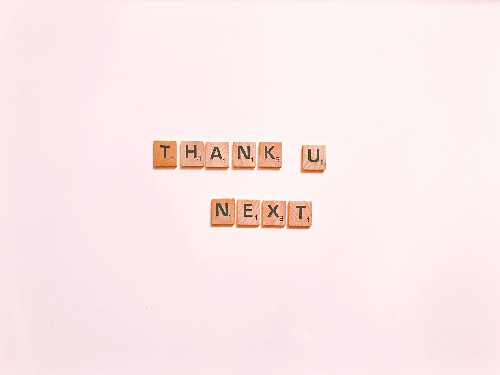 Scrabble tiles display 'Thank U Next' on a clean white background, perfect for creative projects.